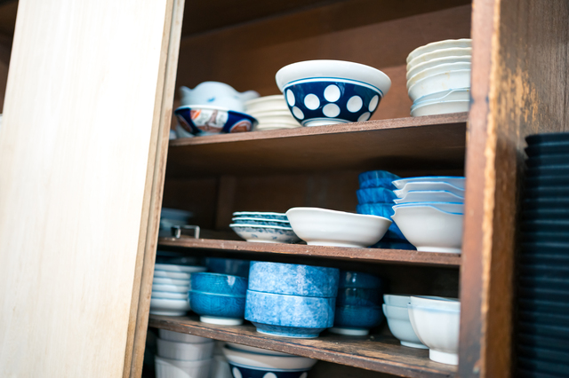 使わない食器が詰まった食器棚の写真